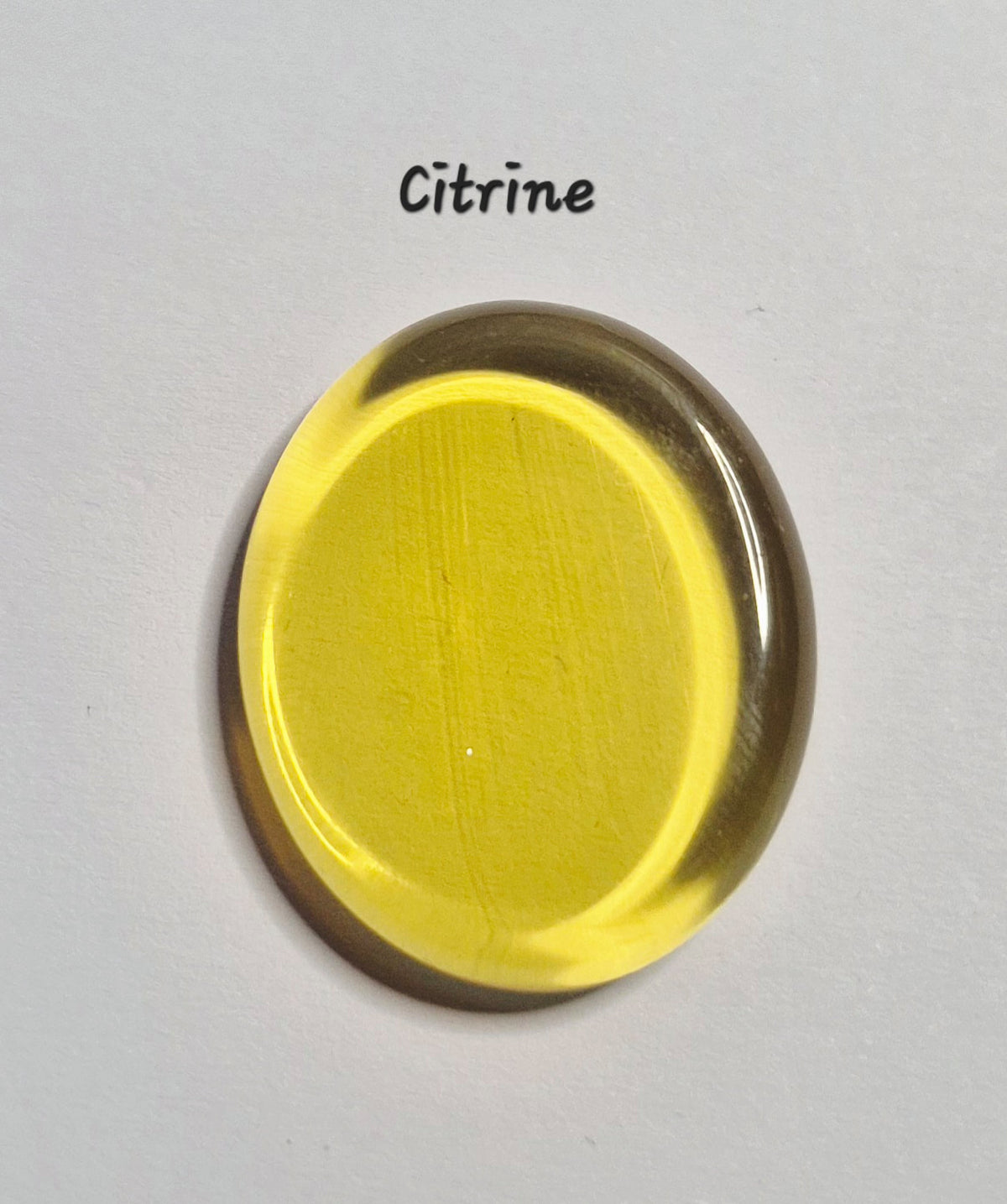 A translucent oval worry gemstone in the color Citrine, labeled with the text 'Citrine' above it, on a plain white background.