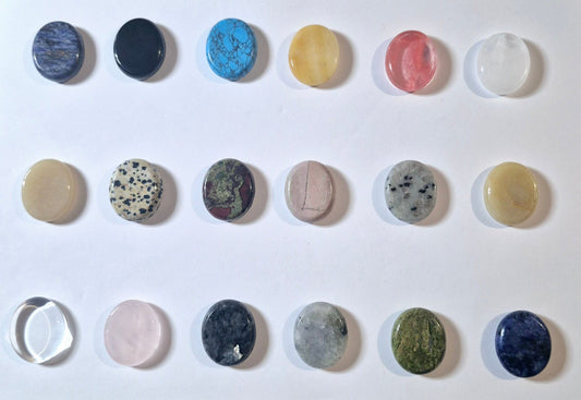 A grid of 15 polished oval gemstone worry stones in various colors and patterns, arranged on a plain white background.