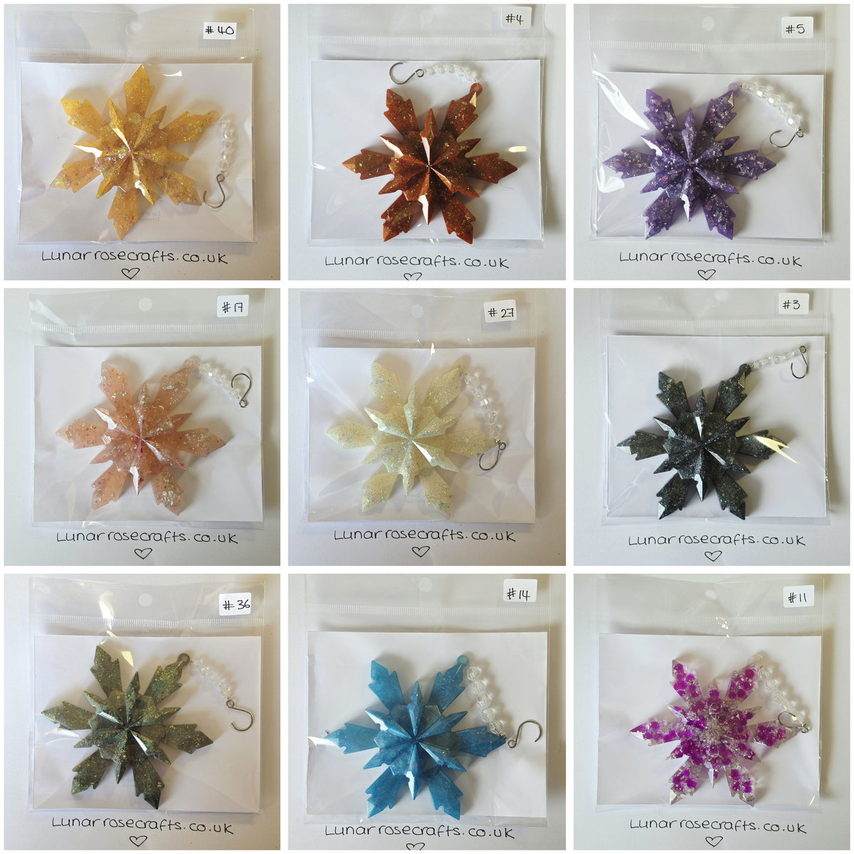 A 3x3 grid showing nine different glittery  snowflake star-shaped hanging decorations in various colours, each individually packaged in a clear plastic bag with a white backing card. The cards are labeled with product codes and the brand name 'Lunarrosecraftsco.uk
