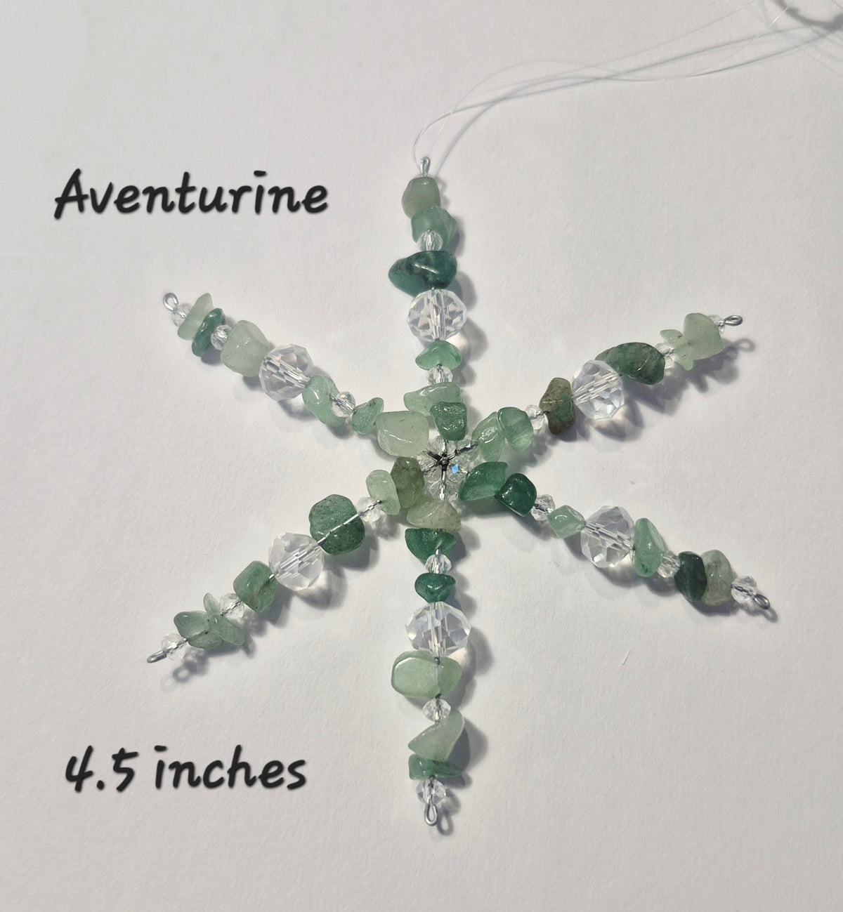 A handmade snowflake-shaped beaded ornament made of green aventurine stones and clear faceted beads, shown on a white background with handwritten text labels reading 'Aventurine' and '4.5 inches'.